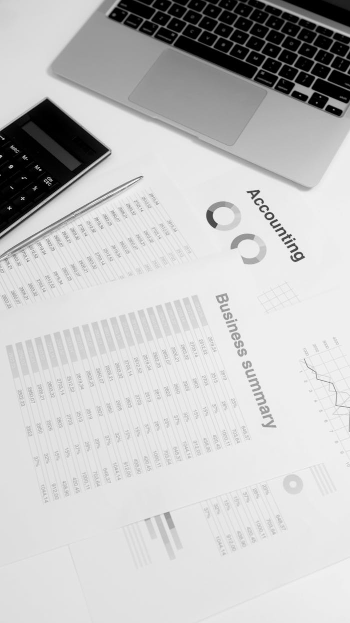 services-01 Overhead view of a workspace with financial documents, laptop, and calculator, ideal for business analysis concepts.